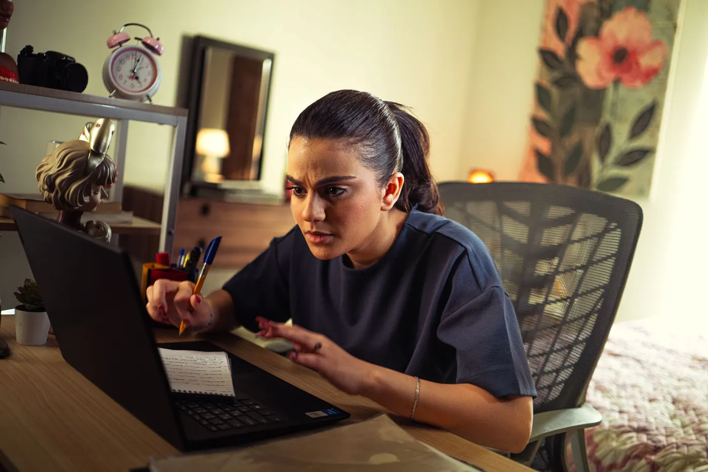 A candidate studying for a securities licensing exam at a desk with a laptop